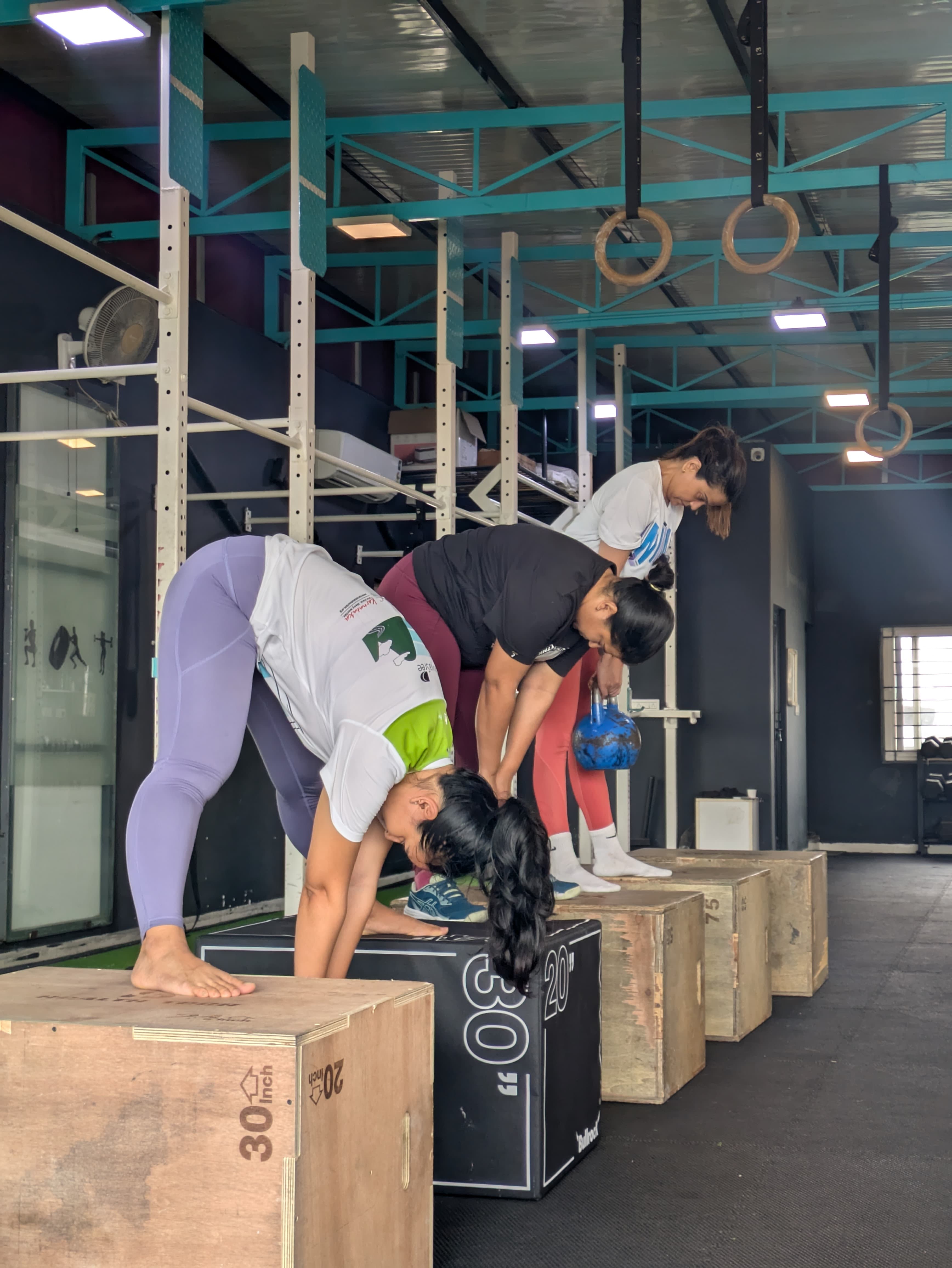Members holding plyo box pike positions at Xthrive HSR Layout, building shoulder strength and mobility.