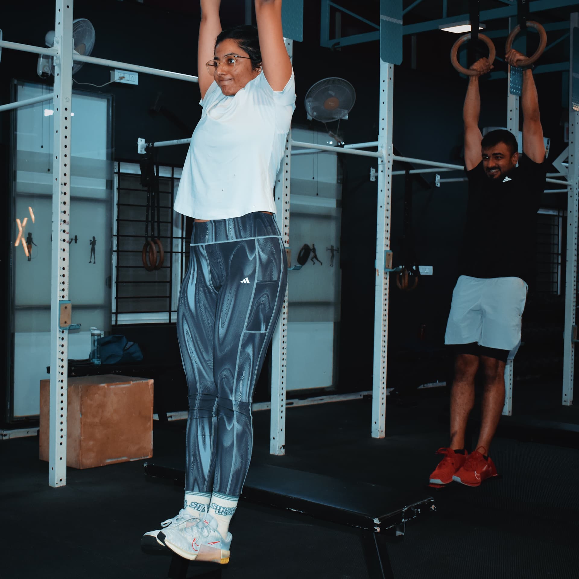 Dead hangs on the pull-up rig at Xthrive HSR Layout gym, scalable for beginners and advanced athletes.